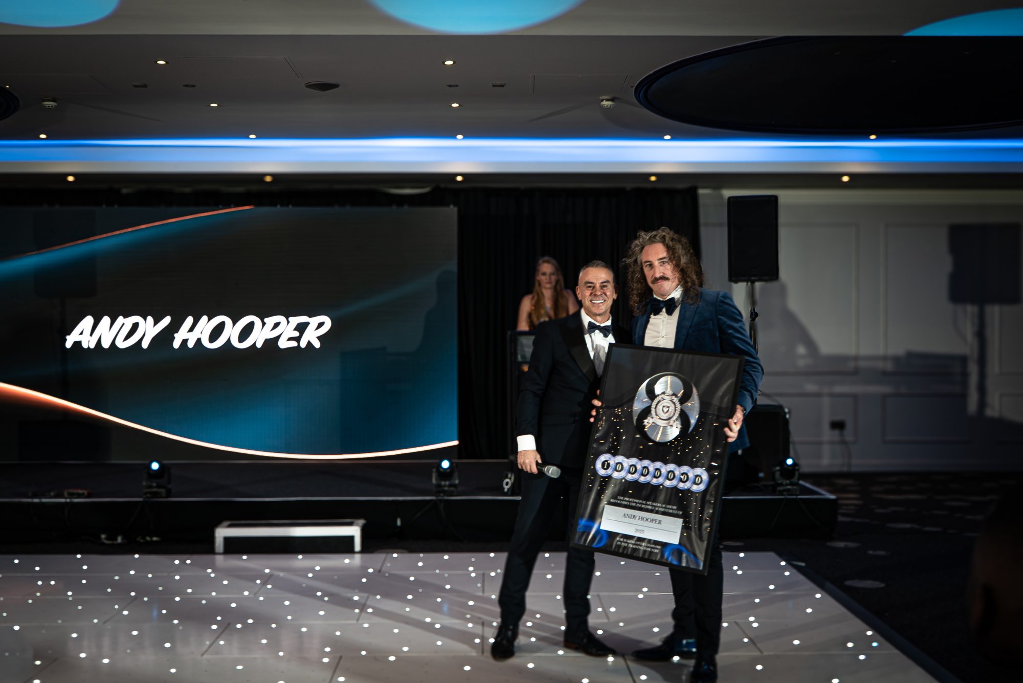 Andy Hooper receiving an award on stage